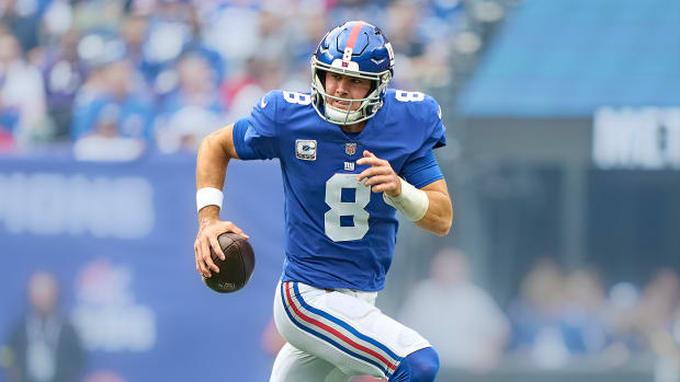 Daniel Jones rolls out of the pocket with the ball